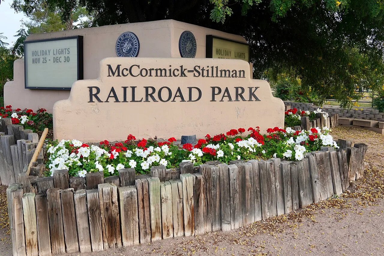 The flower-lined entrance sign of McCormick-Stillman Railroad Park in Scottsdale, Arizona