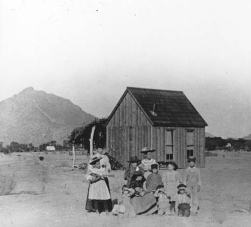 Scottsdale's first one-room wooden schoolhouse, built in 1896, with students gathered outside