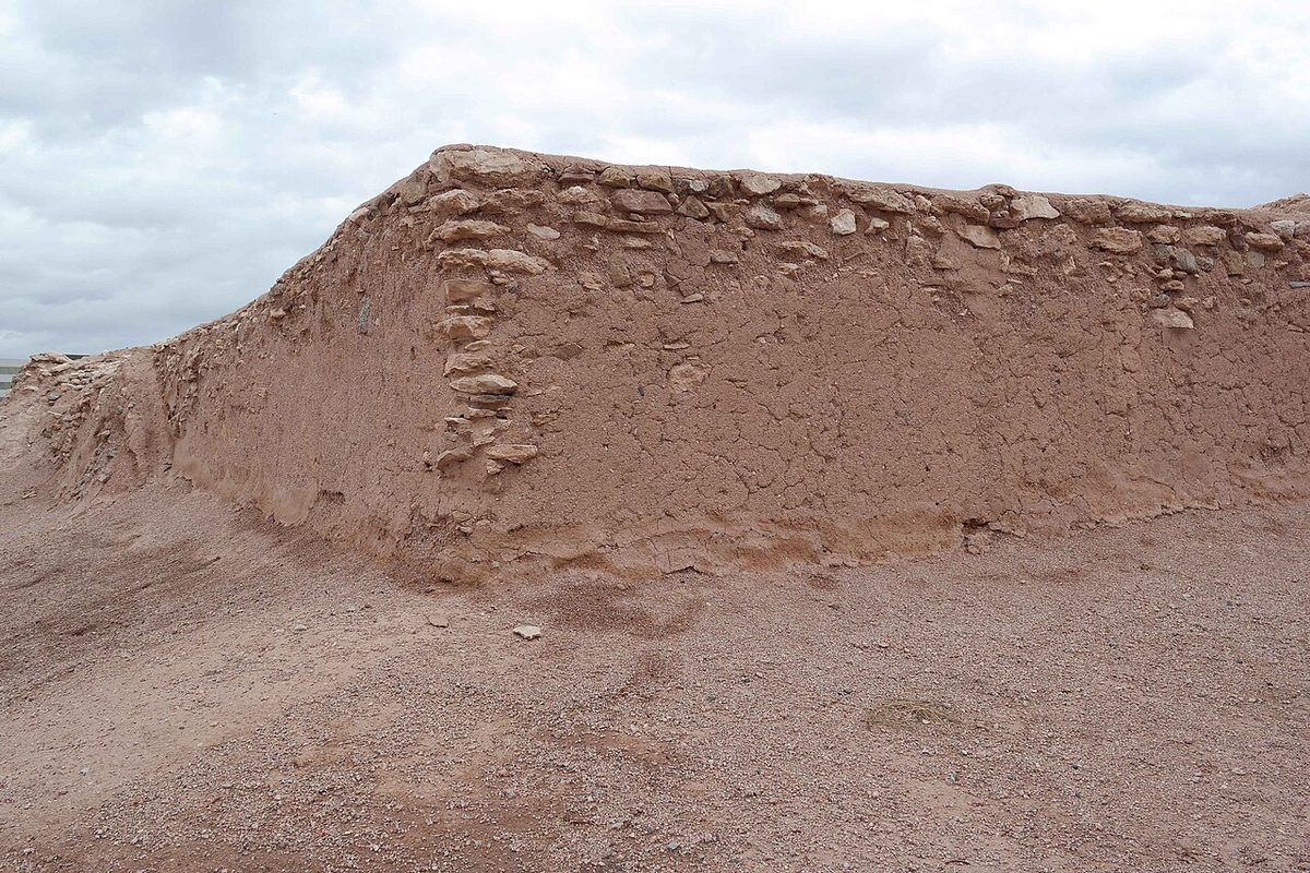 The excavated adobe and stone walls of the Hohokam platform mound at Pueblo Grande in Phoenix, a raised earthen platform with a masonry retaining wall